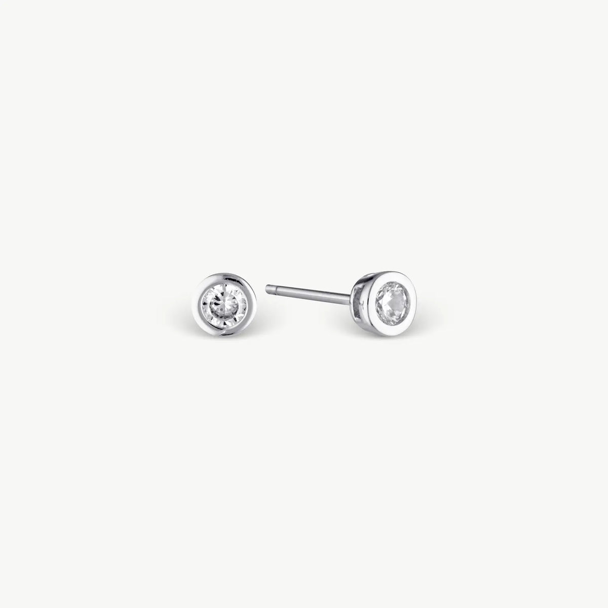 white stud earring with white stone on grey background