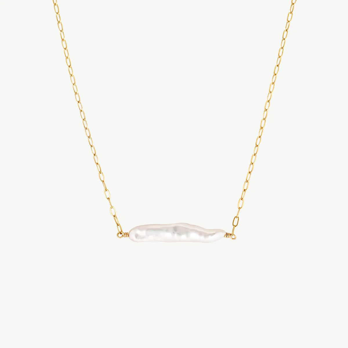 white Horizontal Biwa pearl hanging from a yellow gold chain on a white background