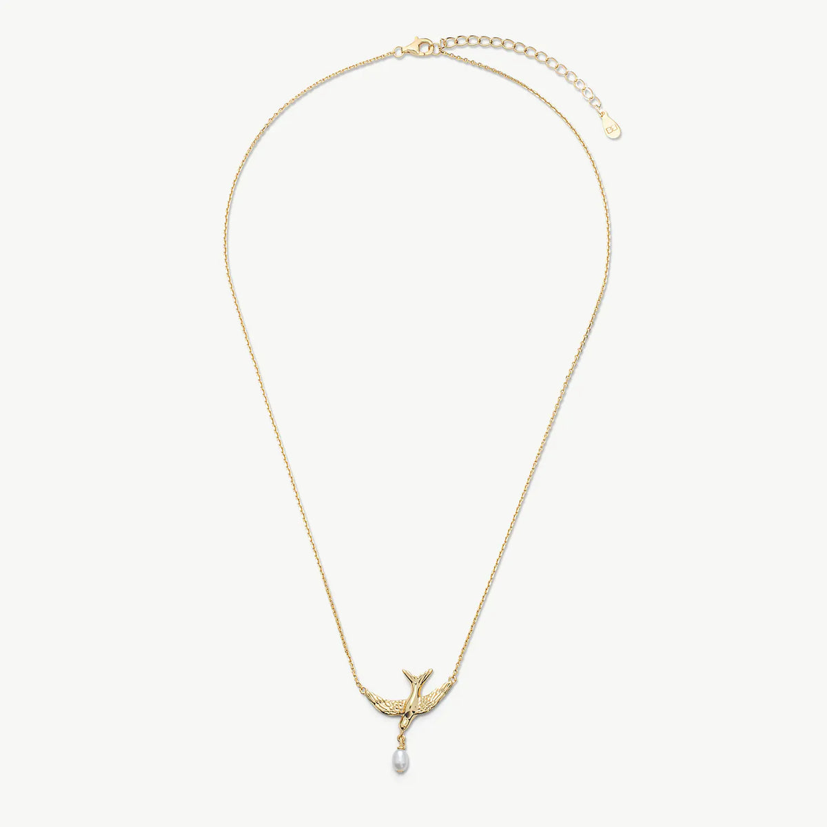 A delicate gold chain necklace featuring a bird-shaped pendant with a small white pearl drop, displayed against a clean off-white background.