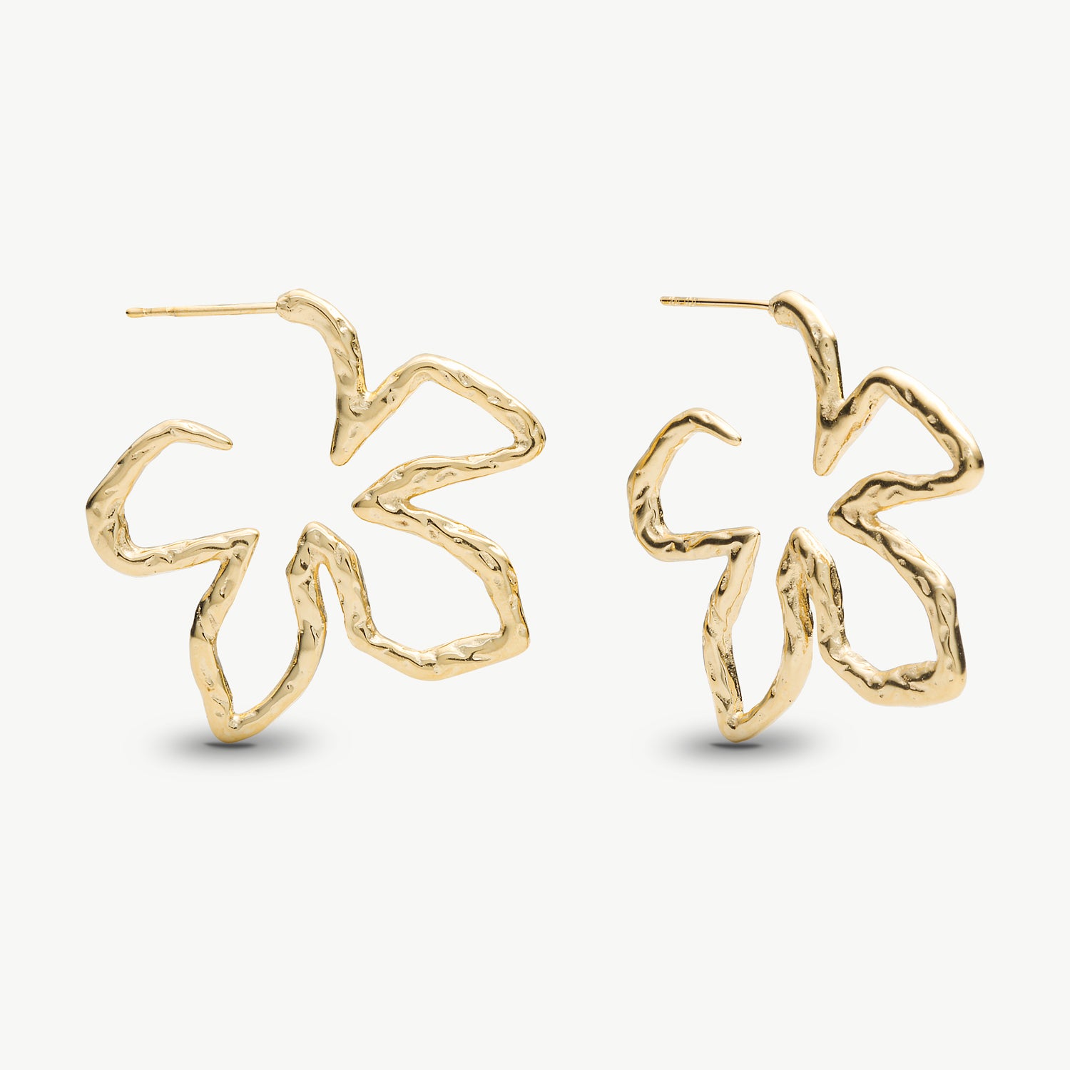 A pair of gold-toned, openwork hoop earrings with a textured, hammered finish, shown on a clean off-white background.