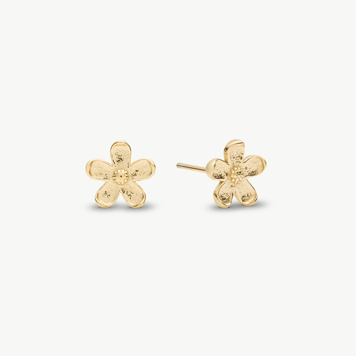 A pair of gold flower stud earrings with a textured, hammered finish, displayed on a clean off-white background.