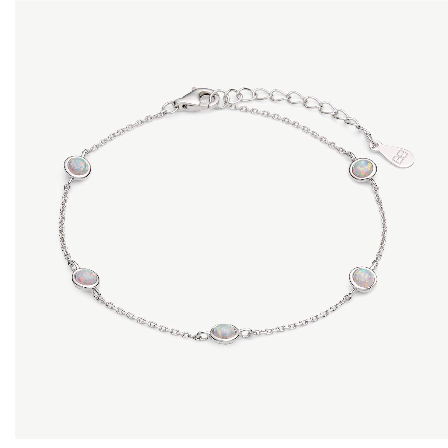 A delicate silver chain bracelet featuring five oval-cut iridescent opal stones, displayed on a clean off-white background.