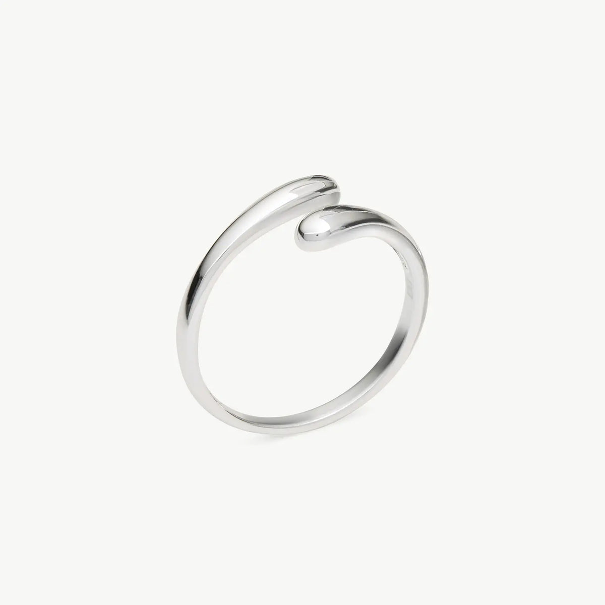 A minimalist silver open wrap ring with a smooth, polished finish, shown on a clean off-white background.