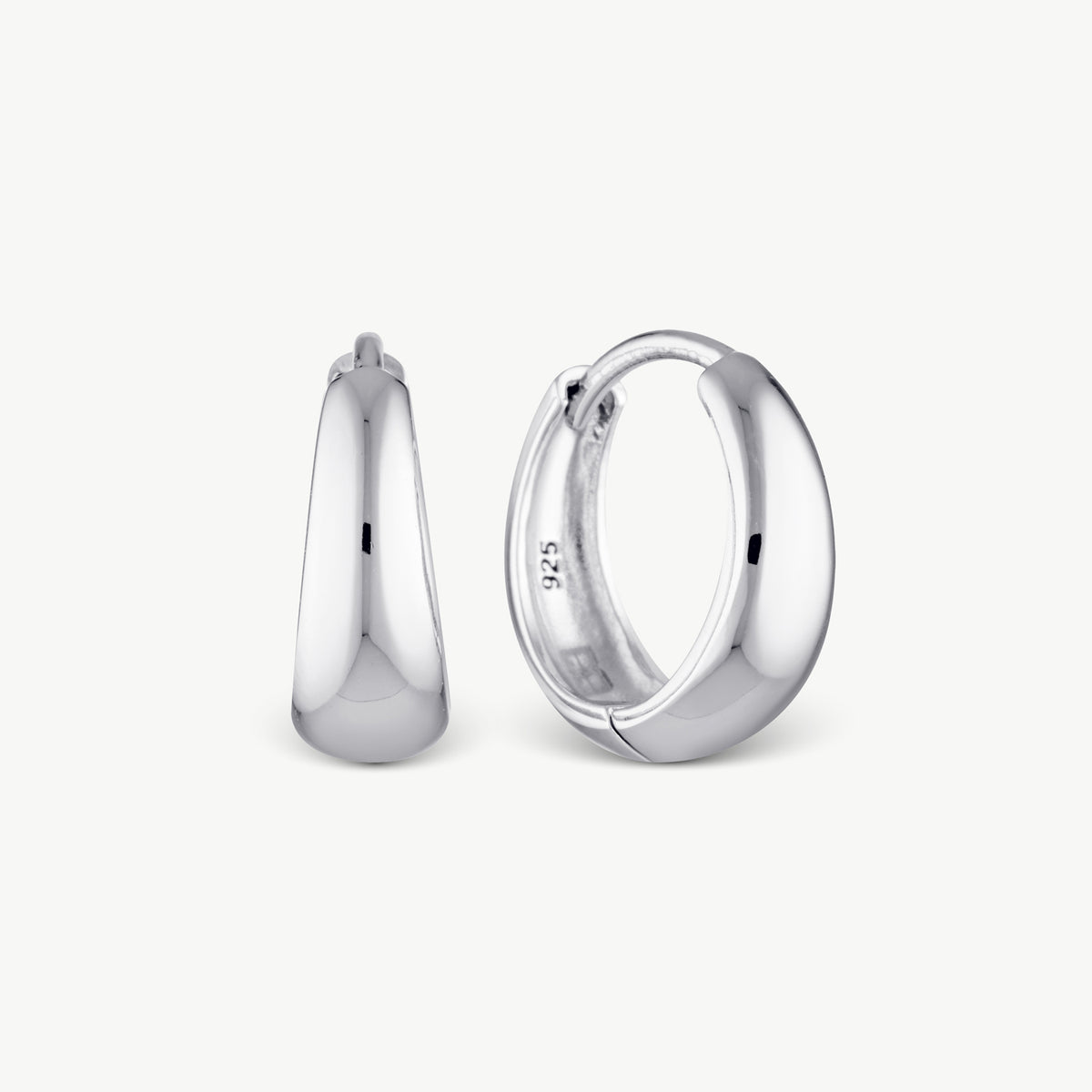 A pair of polished silver huggie hoop earrings shown from front and side views on a clean, light off-white background.