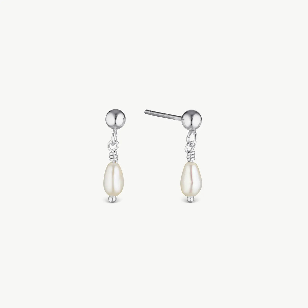 A pair of silver drop earrings featuring a small round silver bead, a delicate twisted wire connector, and a teardrop-shaped cream pearl dangle, shown against a light off-white background.