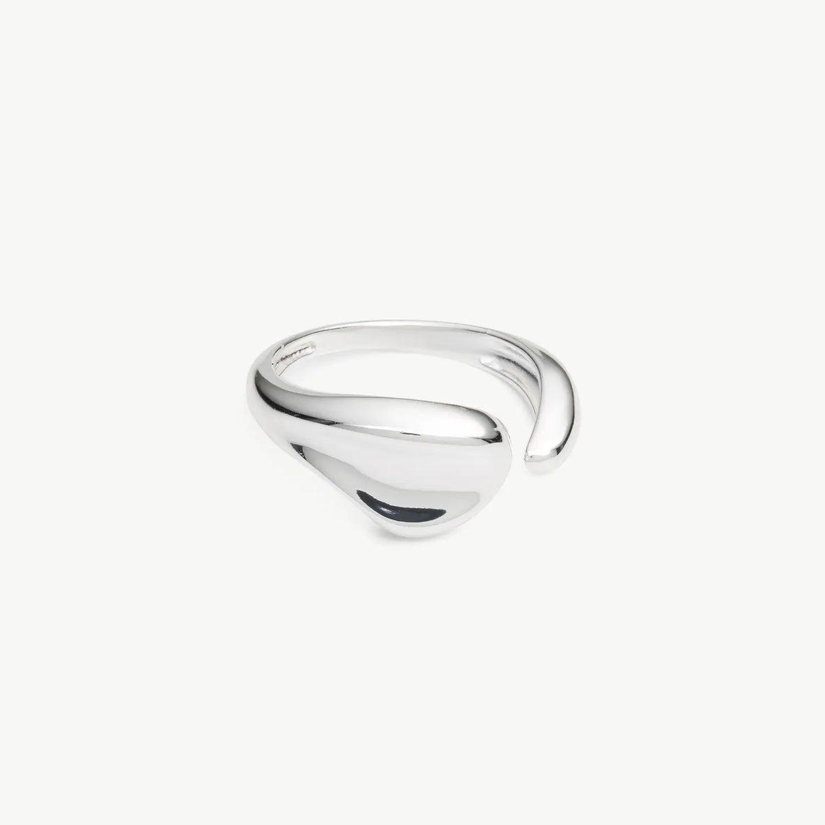Silver open scuplted ring on grey background