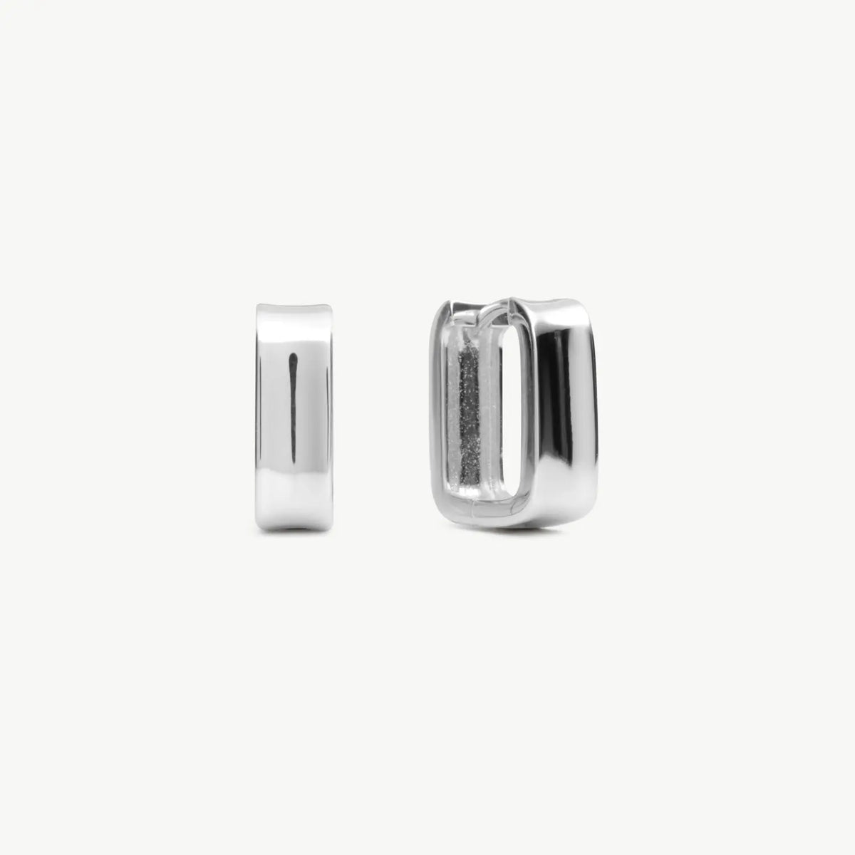 A pair of silver hoop earrings, one shown from the front and the other from the side.