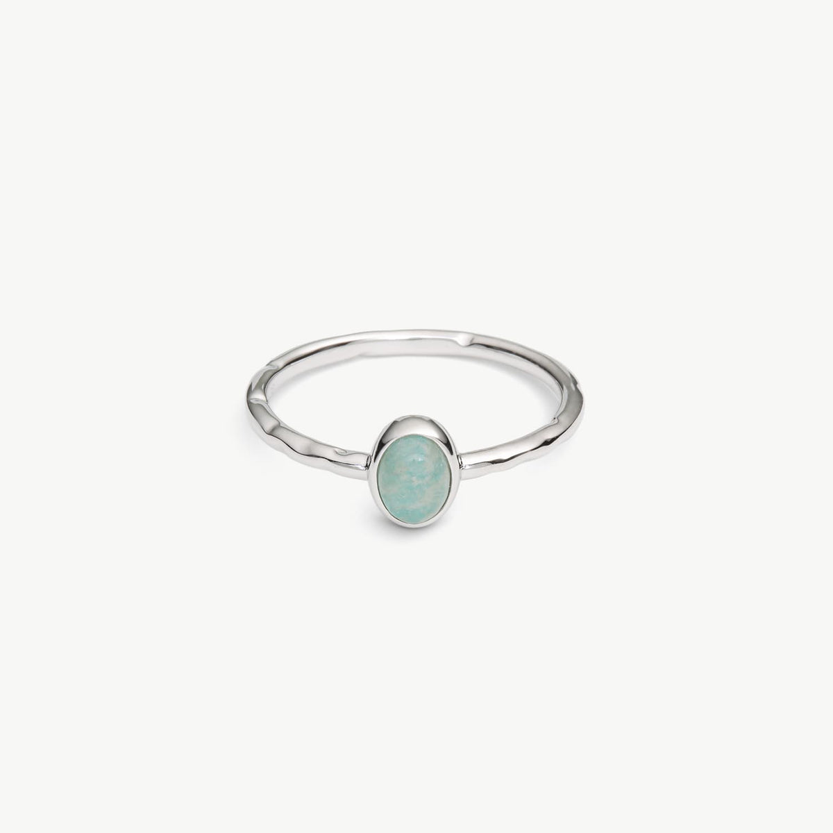 A silver ring with a textured band and a small oval bezel containing a light blue-green stone, shown on a plain white background.