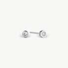 white stud earring with white stone on grey background