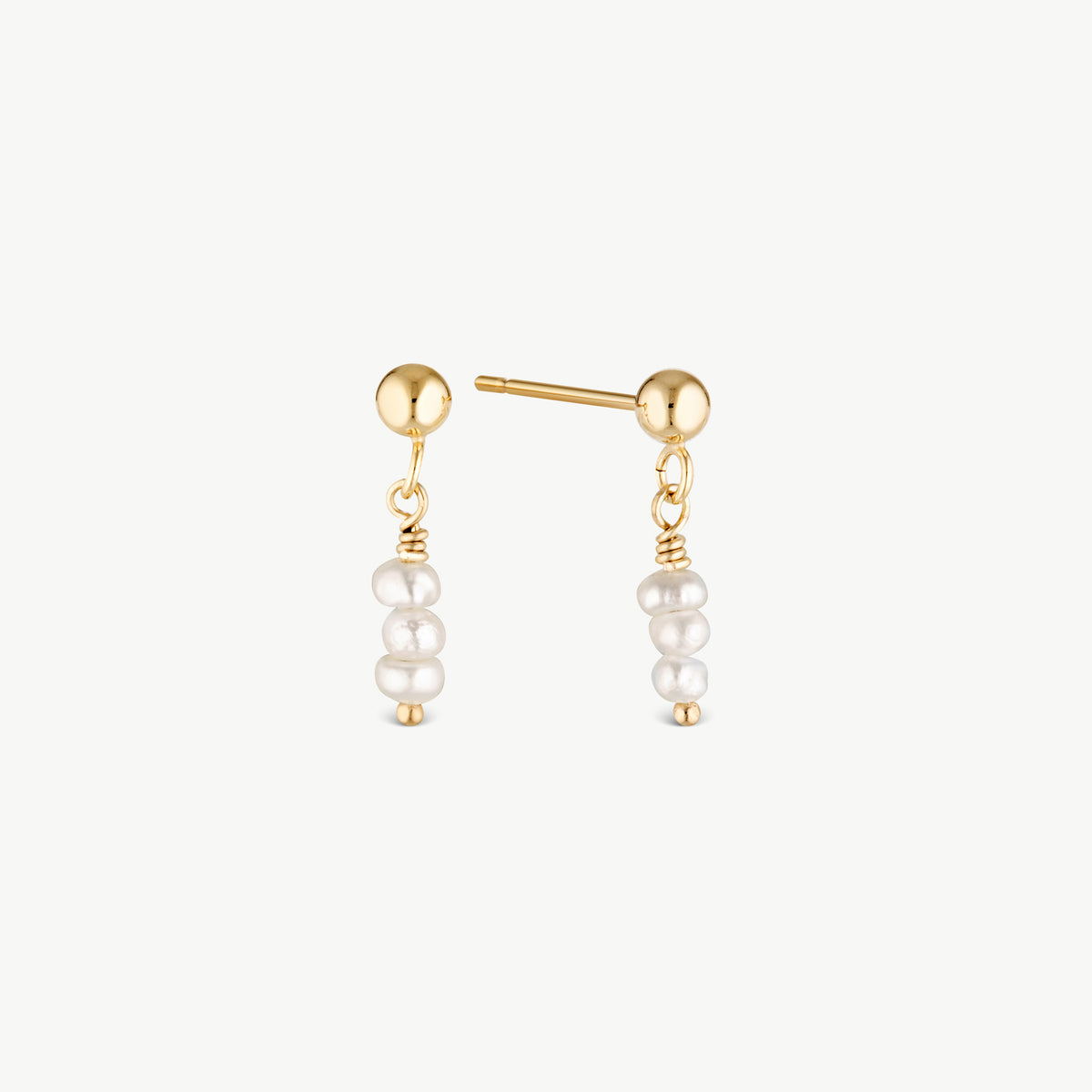 A pair of gold post earrings with a small gold ball at the top and three dangling white pearl beads, shown on a clean off-white background.
