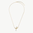 A delicate gold chain necklace featuring a bird-shaped pendant with a small white pearl drop, displayed against a clean off-white background.