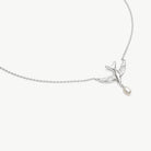 A delicate silver chain necklace featuring a small bird pendant with a dangling pearl, shown on a clean off-white background.