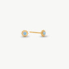 A pair of gold stud earrings with round iridescent opal-like centers, shown on a clean off-white background.