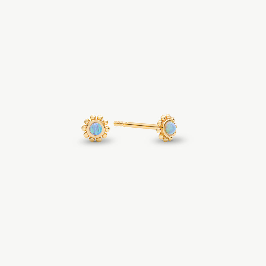 A pair of gold stud earrings with round iridescent opal-like centers, shown on a clean off-white background.
