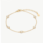 A delicate gold chain bracelet with five oval white opal-like stones, displayed on a clean off-white background. The bracelet features a lobster clasp, an adjustable link chain extender, and a small gold brand tag engraved with 'BH'.