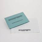 A Bowerbird Jewelry & Stone silver polishing cloth set, featuring a light blue card and a white microfiber cloth on a clean white background.