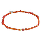 Beaded bracelet with red and gold beads on a white background