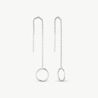 A pair of silver dangle earrings with a minimalist design, featuring a short vertical bar, a beaded chain, and a larger round ring at the bottom, displayed on a clean off-white background.
