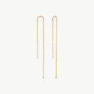 A pair of gold dangle earrings with long chain links and slim cylindrical drop bars, shown on a plain light gray background.