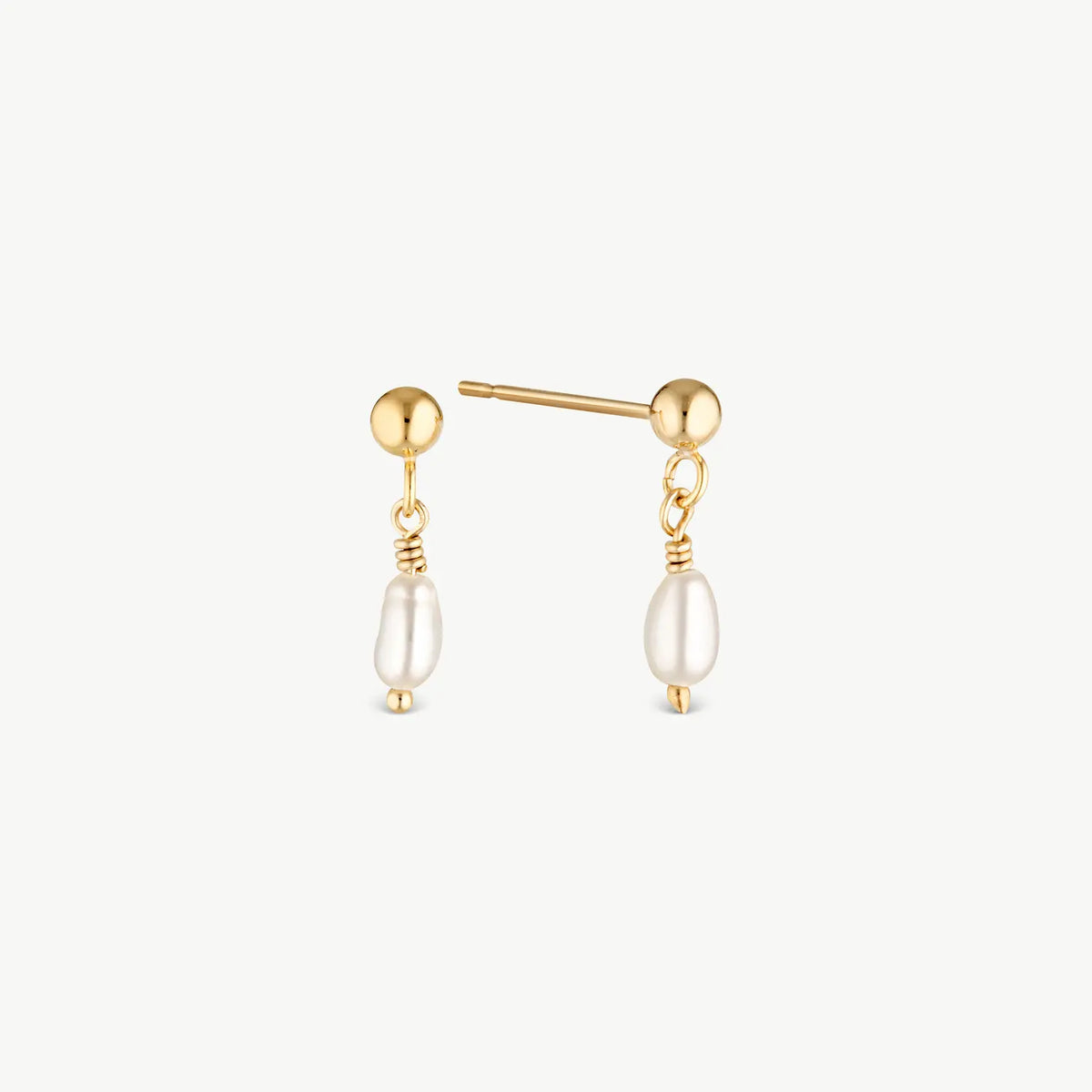 A pair of gold post earrings with a small gold bead, a twisted wire detail, and a dangling baroque pearl on a light gray background.