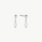 A pair of silver drop earrings featuring a small round silver bead, a delicate twisted wire connector, and a teardrop-shaped cream pearl dangle, shown against a light off-white background.