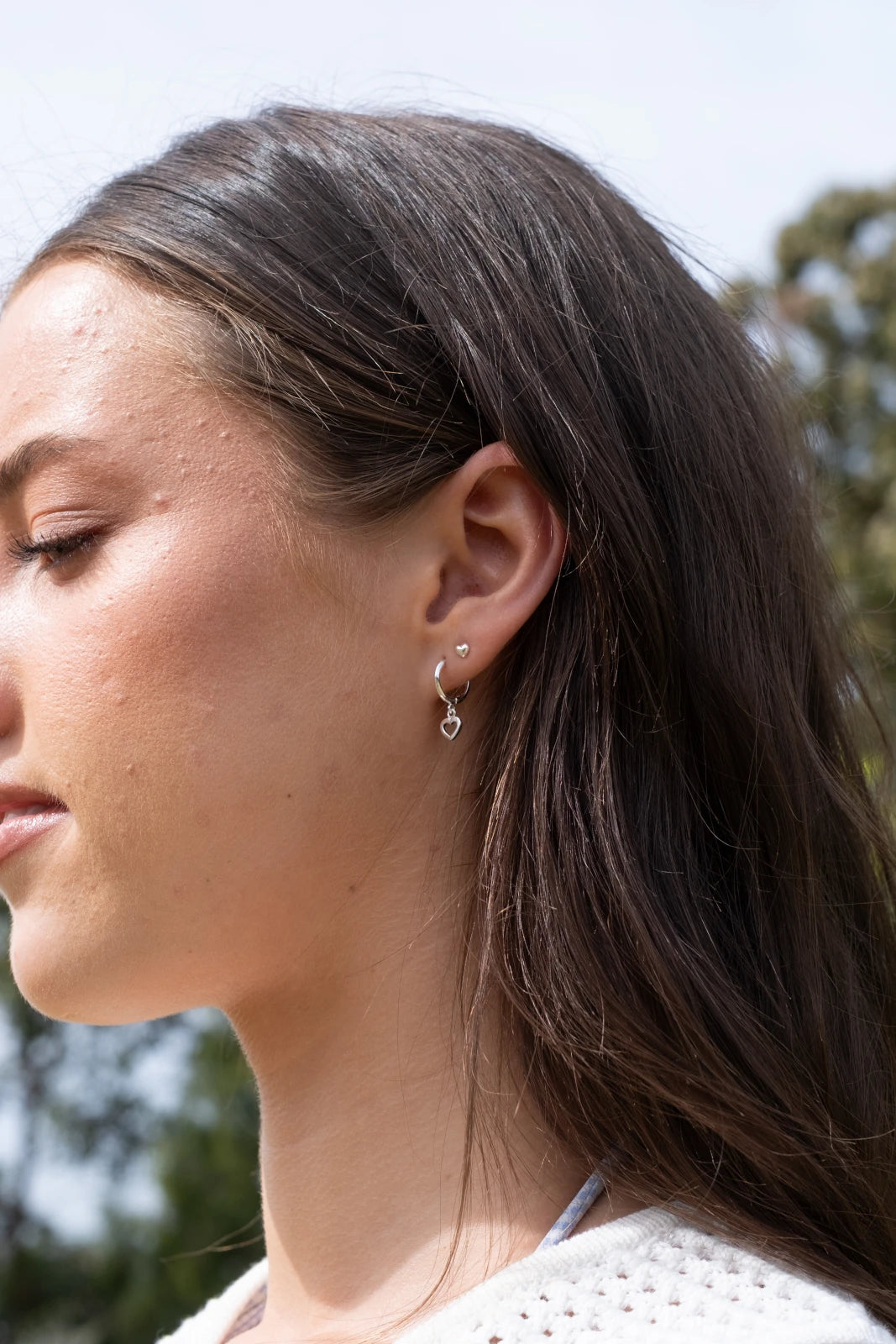 Silver Huggie Earrings with Open Heart Charm on model - Australian Online Jewellery Brand Bowerbird Jewels