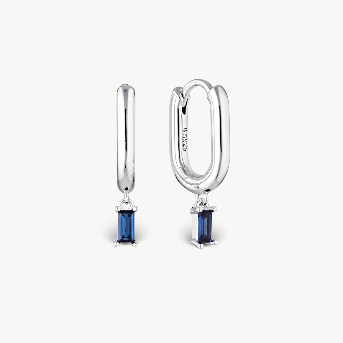 A pair of silver huggie hoop earrings with rectangular blue gemstone drops, shown on a clean off-white background. One earring is shown from the front and the other from the side, revealing an 'S925' engraving on the side hoop.