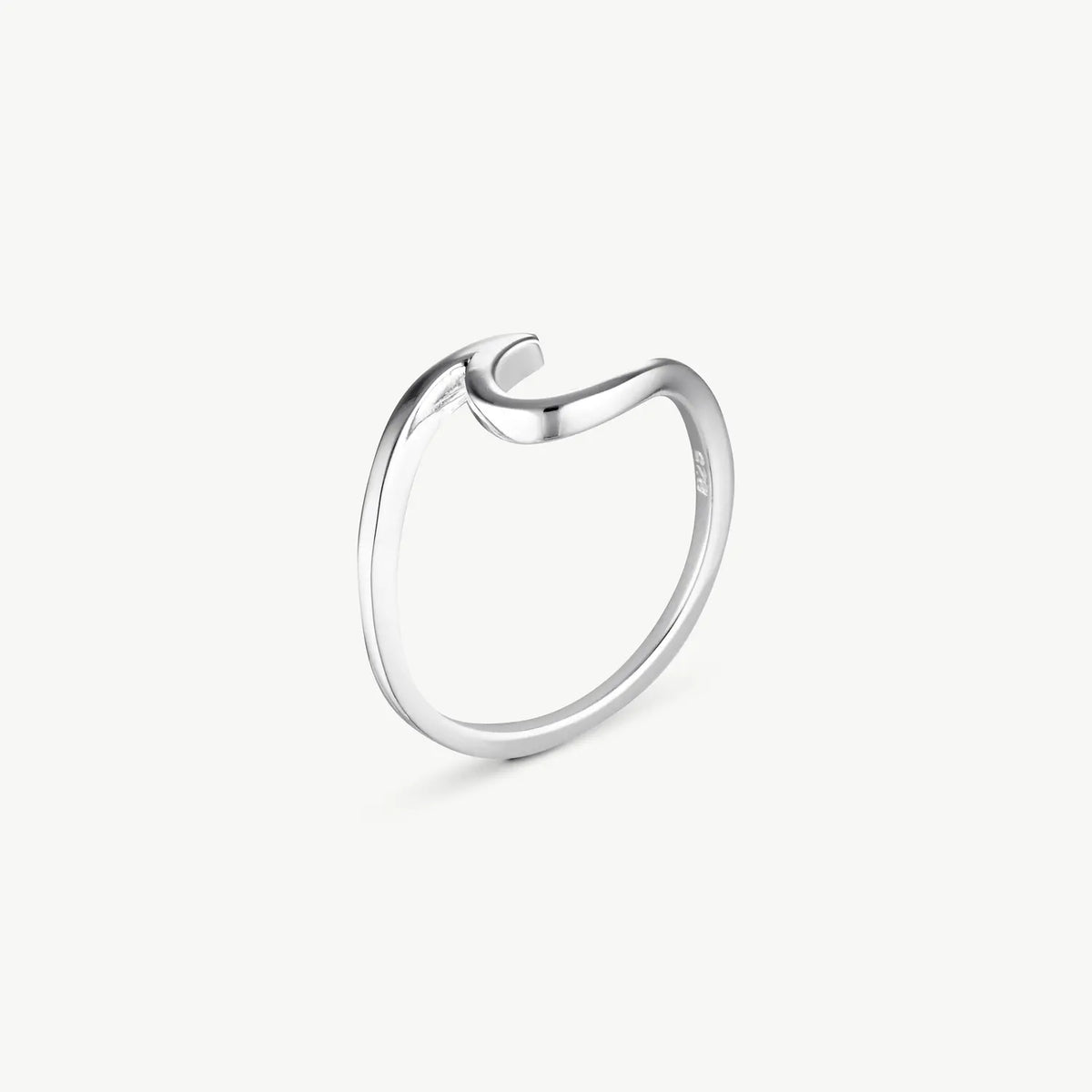 A minimalist silver ring with a unique open, curved design, shown on a clean off-white background.
