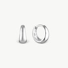 A pair of polished sterling silver huggie hoop earrings shown from two angles, one side profile and one front-three-quarter view, on a clean off-white background.