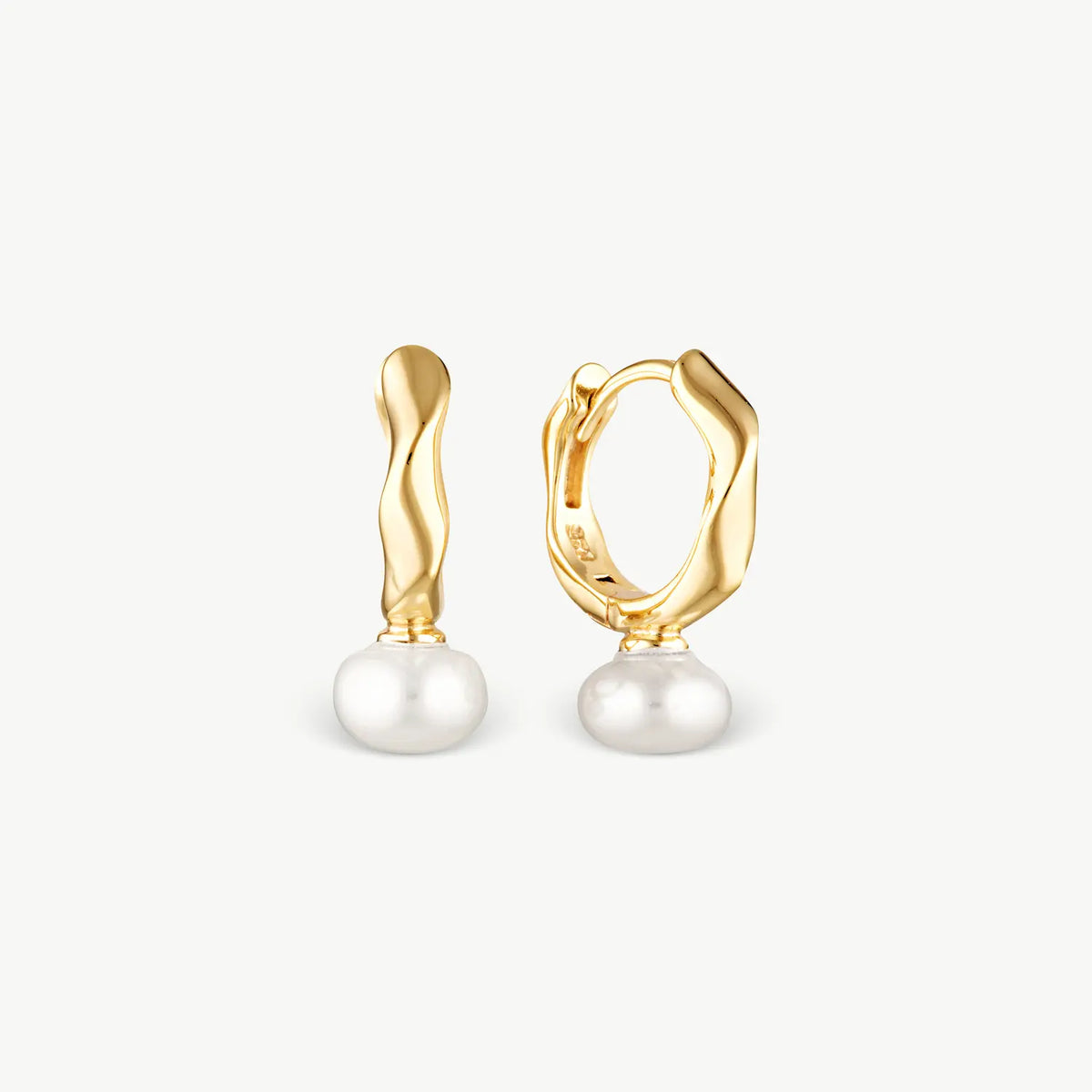 A pair of gold huggie hoop earrings with twisted vertical bars and round white pearl drops, shown against a light gray background.